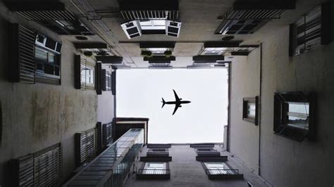 Premium Photo Directly Below Shot Of Airplane Flying Over Buildings