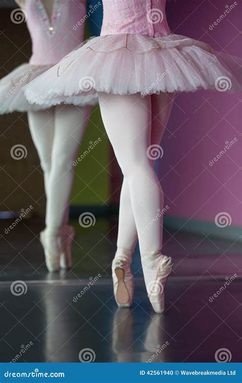 Graceful Ballerina Standing En Pointe In Front Of Mirror Stock Photo