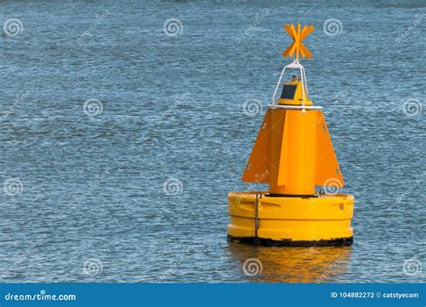 A Yellow Buoy Floating On The Water Surface Stock Photo Image Of