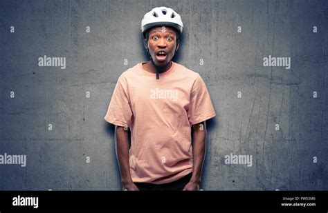 Black Man Wearing Bike Helmet Scared In Shock Expressing Panic And