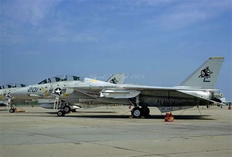 Two Fighter Jets Sitting On Top Of An Airport Tarmac