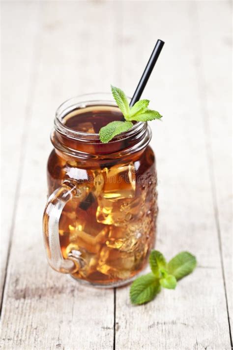 Traditional Iced Tea With Lemon Mint Leaves And Ice Cubes In Glass Jar