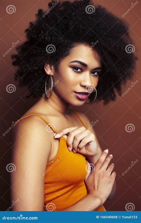 Pretty Young African American Woman With Curly Hair Posing Cheerful