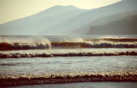 Beach with waves at sunset stock photo. Image of inch - 4563730