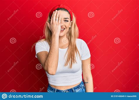 Young Caucasian Woman Wearing Casual White T Shirt Covering One Eye