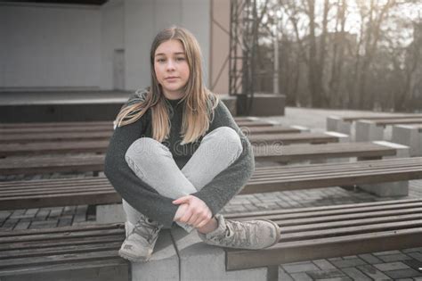 Sad Teen Girl on a Bench in the Park. Single Girl Outdoor Stock Image ...