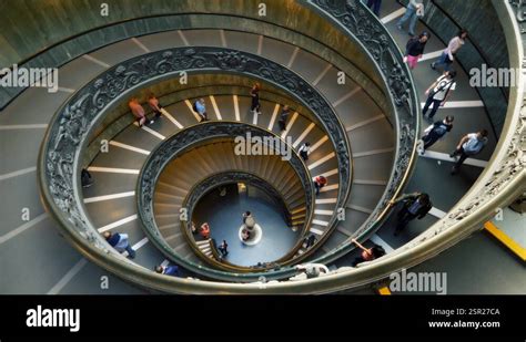 Tourists On Bramante Spiral Stairs At Vatican Museums In Rome Italy