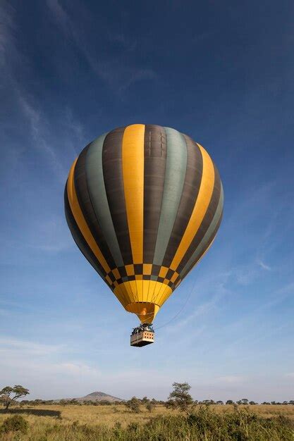 Premium Photo Hot Air Balloon Flying Over Field