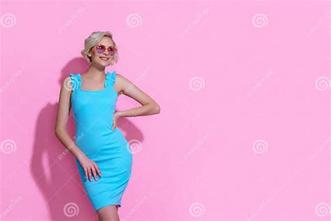 Portrait Of Beautiful Blonde Woman In Blue Dress With Sunglasses Posing