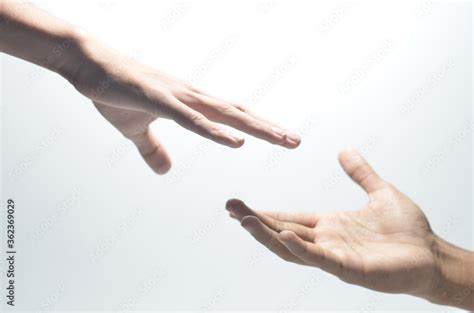 Two Male Hands Reaching Towards Each Other On Isolated White Background