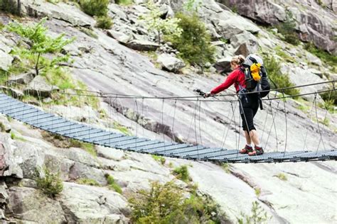 Woman Trekking With Backpack Crossing Bridge Stock Image Everypixel