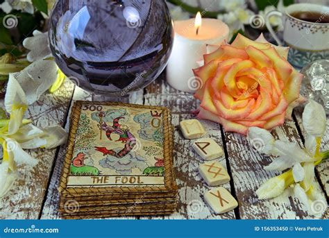 Tarot Cards Deck Crystal Ball Runes And Flowers On Witch Table Stock