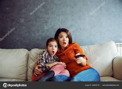 Surprised Mother Daughter Sitting Sofa Watching Horror Movie Mother