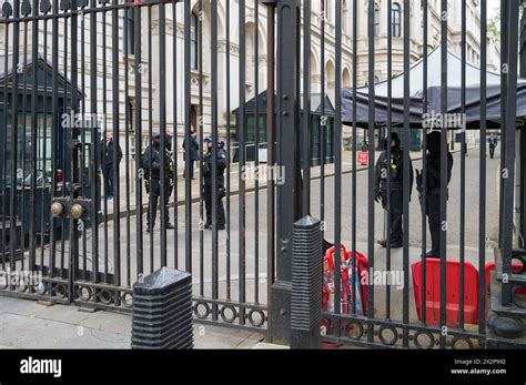 Armed Police On Guard Inside The Iron Gates At The Entrance To Downing