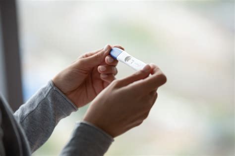 Close Up Of Woman Hands Holding Positive Home Pregnancy Test FamPlan