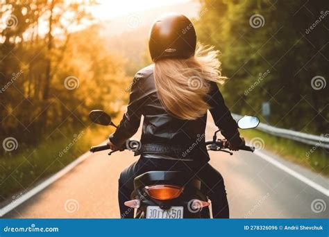 Back Of Blonde Biker Girl In A Leather Jacket And Helmet Riding On