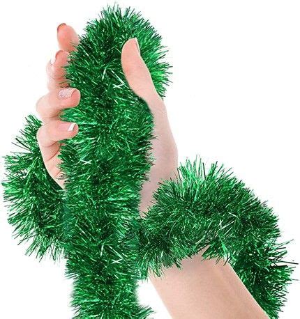 Two Hands Are Holding Green Tinsel