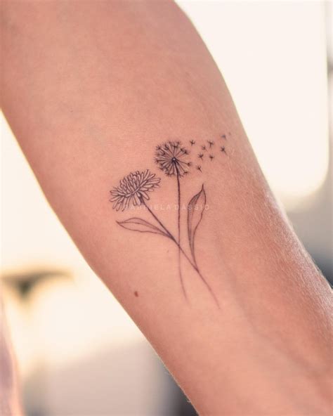 A Woman S Arm With A Dandelion Tattoo On It