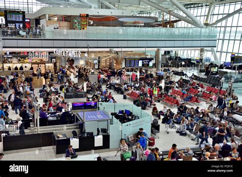 Inside Heathrow airport terminal 5 departures waiting area with seating ...