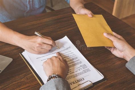 Bribery A Man Giving Bribe Money In A Brown Envelope To Another Stock