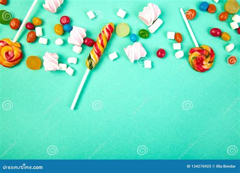 Colorful Candies On Pastel Turquoise Background Flat Lay Stock Image