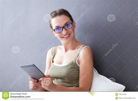 Attractive Caucasian Girl Sitting On Floor With Cup And Tablet Near