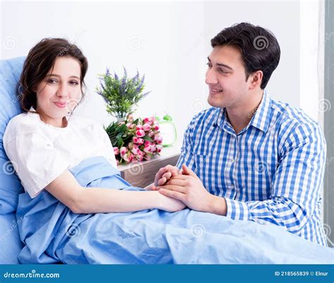 Caring Loving Husband Visiting Pregnant Wife In Hospital Stock Image