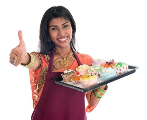 Premium Photo Woman Wearing Sari While Holding Cupcakes In Tray Against White Background