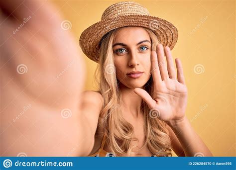 Young Beautiful Blonde Woman On Vacation Wearing Bikini And Hat Making