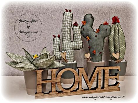 A Wooden Sign That Says Home Surrounded By Cacti And Succulents