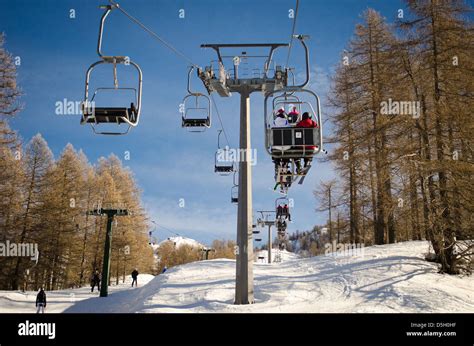 People And Skiers On Chairlift Aerial Lift And Skilift In Sunny Day