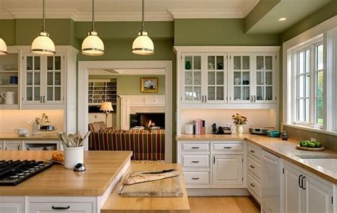 white kitchen cabinetry with wooden furnishings and green walls - Decoist