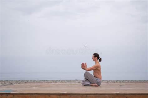 Caucasian Man With Naked Torso Practicing Wushu On The Seashore Stock