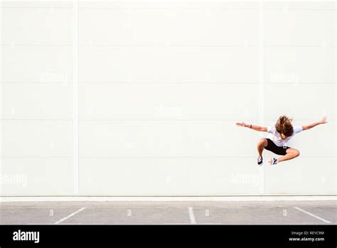 young man jumping mid air stock photo alamy