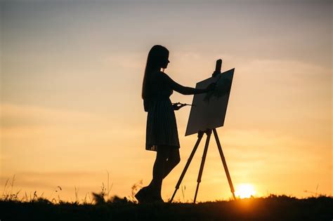 Premium Photo Silhouette Of A Blonde Girl Artist Paints A Painting On