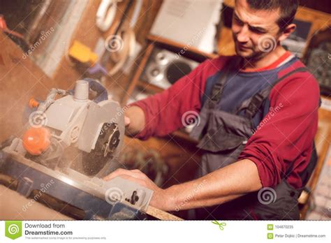 Carpenter Using Circular Saw For Cutting Wooden Boards Stock Image