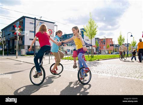 Children On Unicycles In A Play Street Vauban District In Freiburg Im