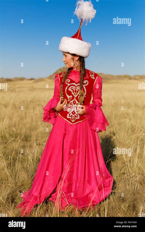 Beautiful Kazakh Woman In National Costume Dancing In The Steppe Stock