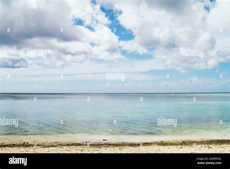 A Scenic View Of Fluffy White Clouds Over Sandy Tumon Beach Guam USA