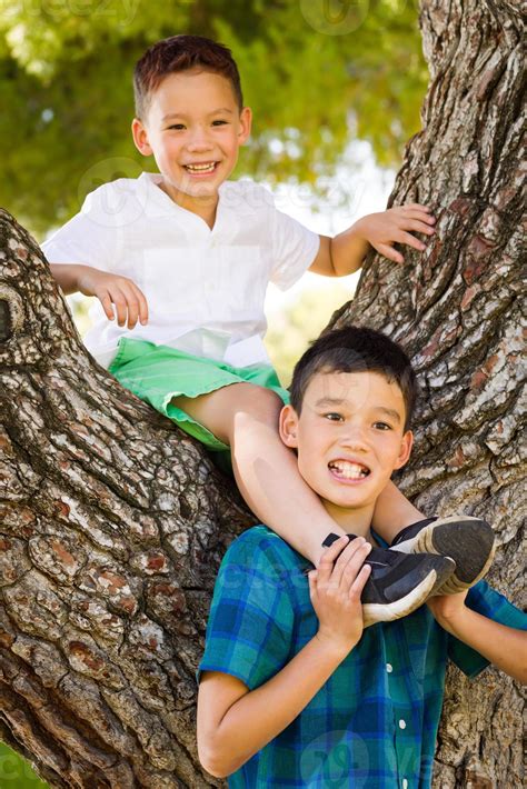 Outdoor Portrait Of Biracial Chinese And Caucasian Brothers Having Fun