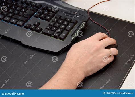 Guy is Playing a Video Game. Close Up of a Hand Lying on a Mouse and a ...