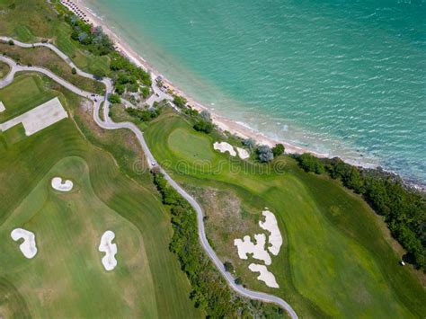 Aerial View Of The Golf Course Stretches Out Beneath Its Lush Green