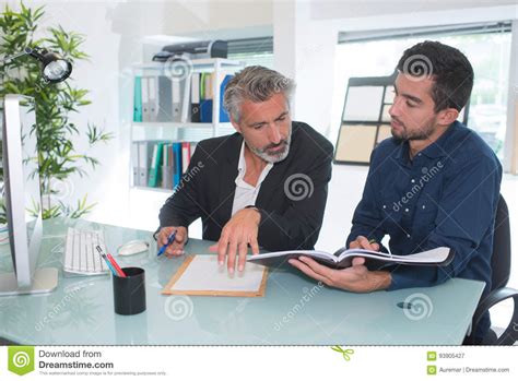 Two Young Businessmen Talking In Office Stock Image Image Of Looking