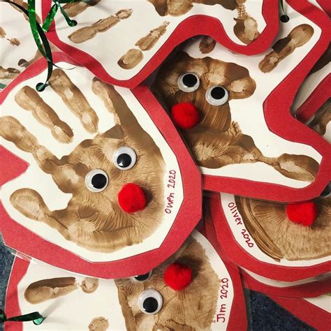 Handprinted Christmas Ornaments With Red Pom Poms