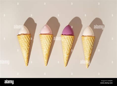 Cosmetic sponges styled creatively as ice cream scoops in waffle cones ...
