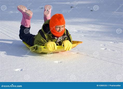 Girl Sledding On Snow Covered Lake Stock Image Image Of Youth