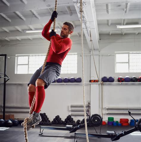 Fitness rope climb exercise at gym