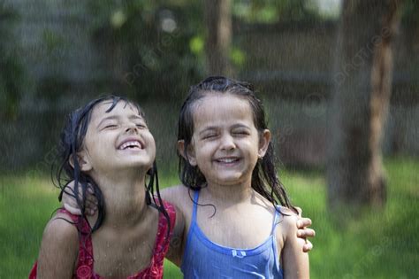 Close Up Of Cheerful Girls Enjoying In Rain Photo Background And