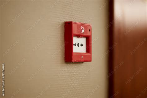 Red fire alarm button. Red fire alarm button on the wall in the room ...