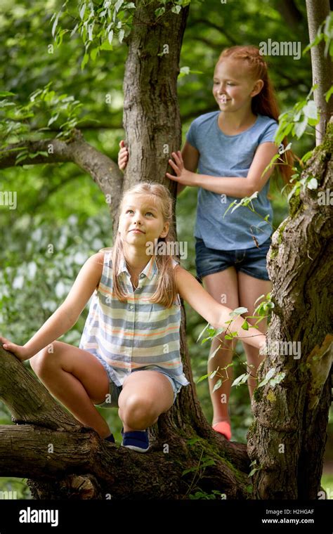 Two Young Girls Climbing Tree Hi Res Stock Photography And Images Alamy